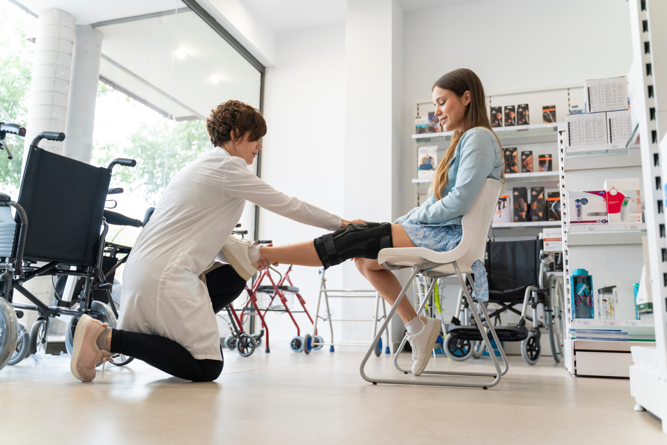A patient being fitted with an orthopedic brace by a specialist